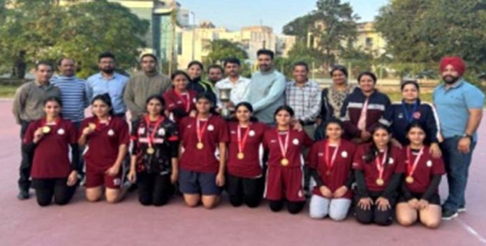 Winning team posing along with trophy.
