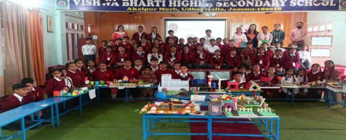 Students displaying their creative ‘best out of waste’ projects during competition.