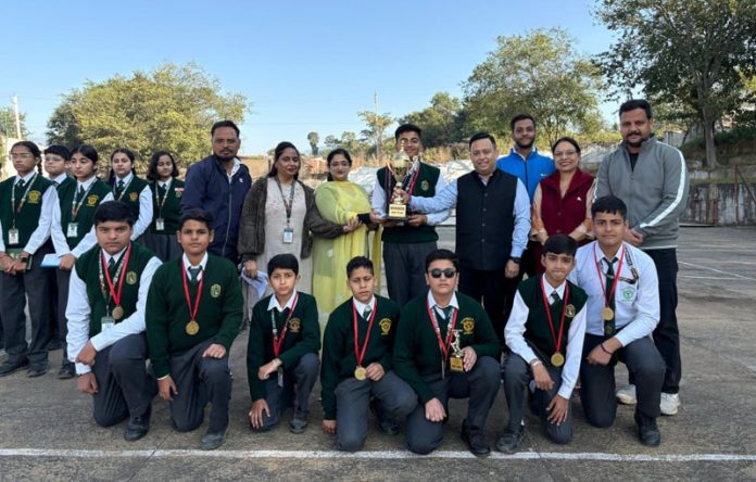 Winning team posing along with trophy.