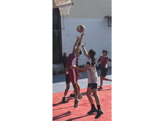 Players in action during a Basketball match at MA Stadium, Jammu.