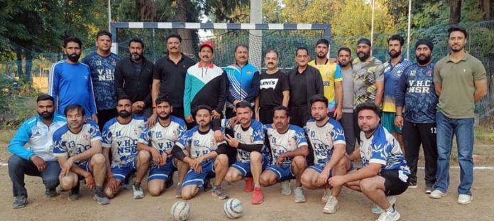 Handball players posing for a group photograph.