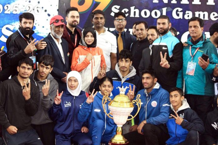 J&K Wushu team along with dignitaries posing with trophy. J&K Wushu team along with dignitaries posing with trophy.
