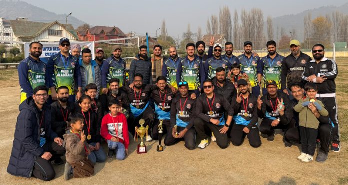 Winning team posing along with trophy.
