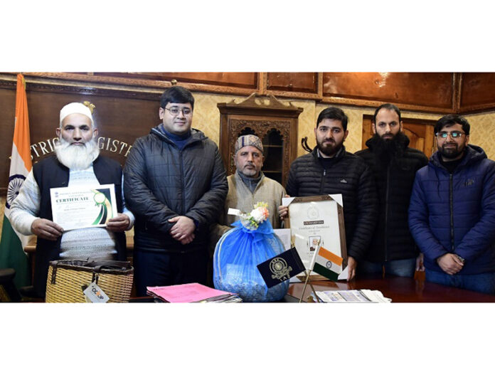 Award winning Willow Wicker craftsmen Bashir Ahmad Dar and Mehraj ud din Pir posing with DC Ganderbal Jatin Kishore.