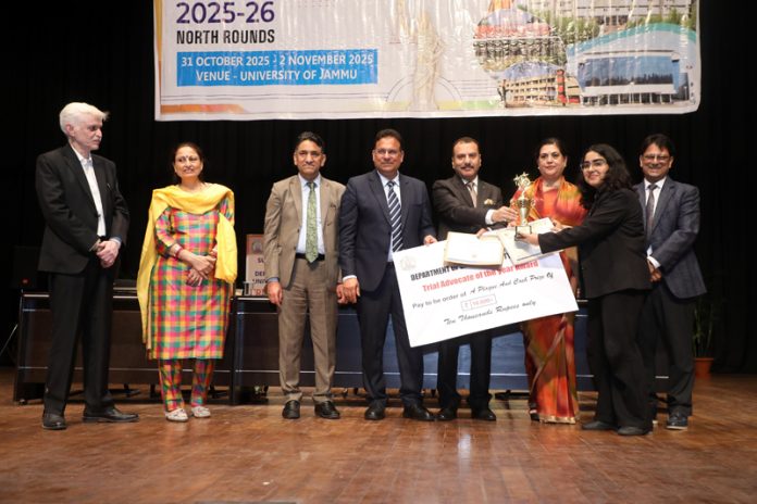 Dogra Law College student receiving cheque and certificates from dignitaries.