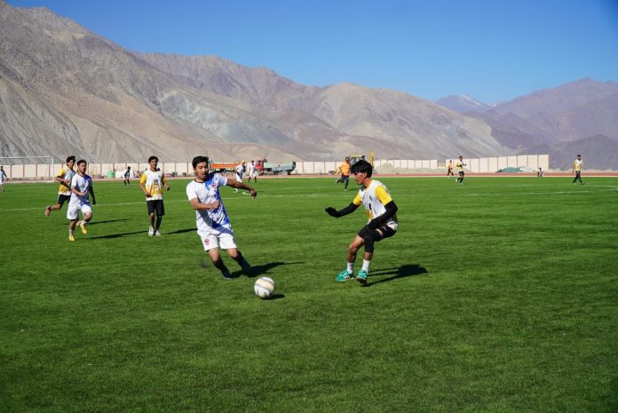 Football players in action during a match at Kargil.