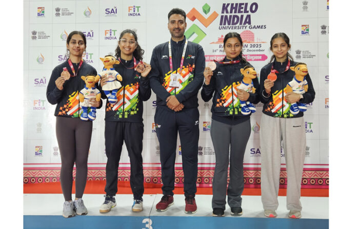 Winning team posing along with medals.