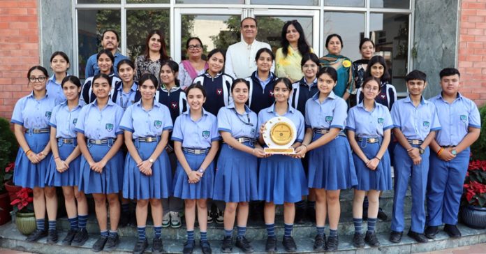 Students of Heritage school posing along with trophy alongside management.