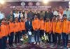 Minister posing with players and dignitaries during inuauguration of 42nd Jr. National Tennikoit Championship.