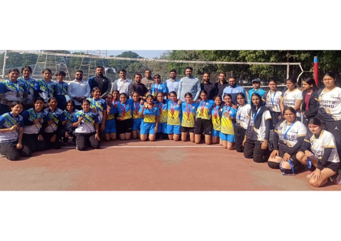 GDC Ramnagar Volleyball team posing along with medals.