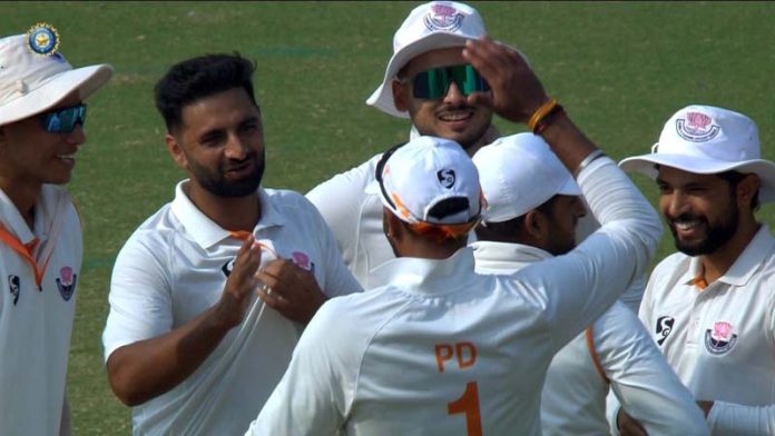 Aquib Nabi celebrating with team players after taking a wicket against Delhi.