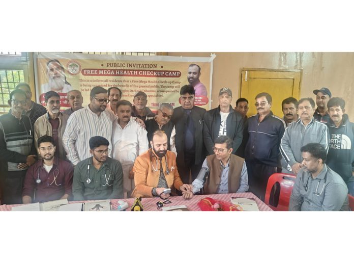 HoD Cardiology GMC & SSH Jammu Dr Sushil Sharma examining people at Jagti on Sunday.