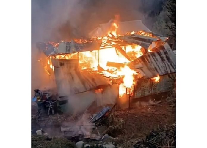 Residential house engulfed in flames.