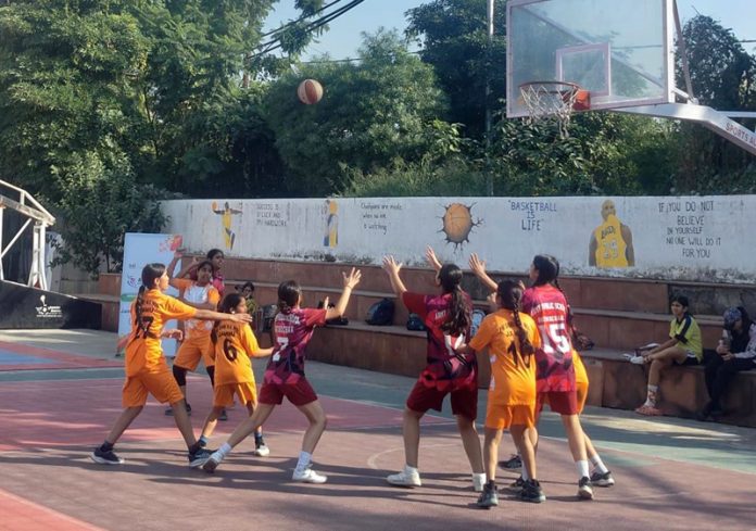 Players in action during a Basketball match at Jammu.