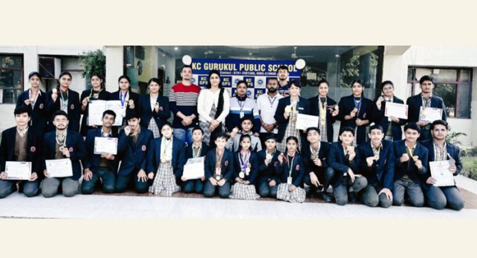 Students posing along with school management during a programme.
