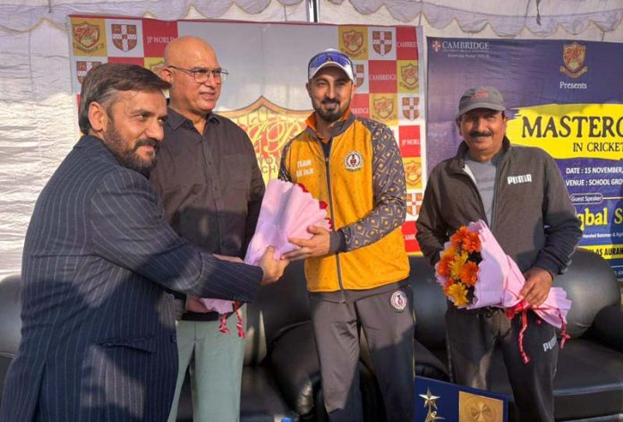 School management presenting bouquet to ex-cricketer at JP World School. School management presenting bouquet to ex-cricketer at JP World School.
