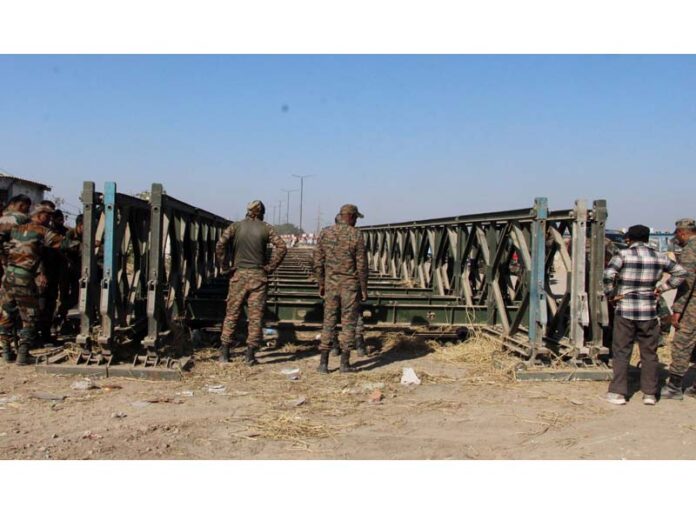 Army personnel dismantling Bailey bridge over River Tawi on Friday. -Excelsior/Rakesh