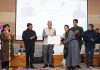 Ladakh LG Kavinder Gupta distributing loan sanction letters to beneficiaries during an event in Leh on Friday.