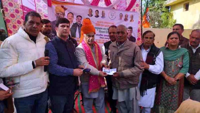 BJP general secretary (Org), Ashok Koul distributing Ayushman cards at Khour in Chamb constituency on Wednesday.