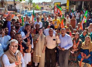MP Jugal Kishore and BJP candidate Devyani Rana during election campaign in Jhajjar Kotli area on Sunday.