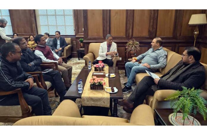 Minister Satish Sharma chairing a meeting at Jammu on Friday.