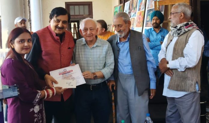 Dr Raj Kumar Sharma giving away the first prize to the winner of painting competition. Dr Raj Kumar Sharma giving away the first prize to the winner of painting competition.