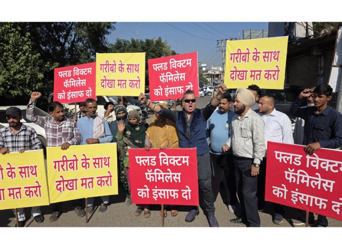 Flood victims displaying placards during a protest in Jammu on Thursday. -Excelsior/Rakesh