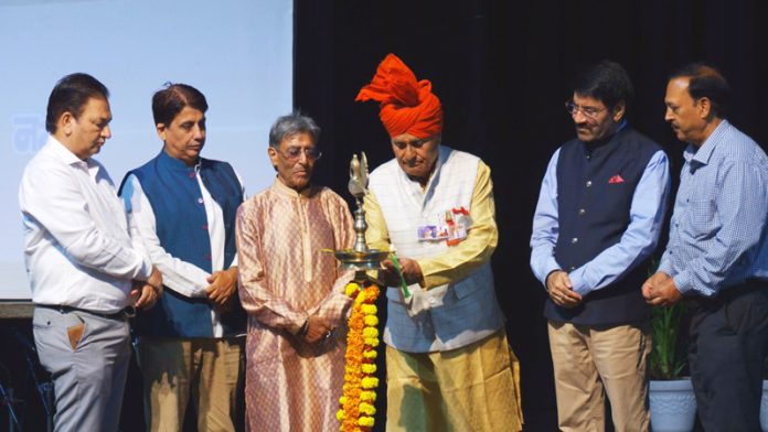 Dignitaries lighting the traditional lamp during an event in Jammu.