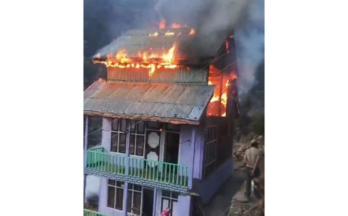A house on fire in Padder area of Kishtwar on Friday. -Excelsior/Tilak Raj