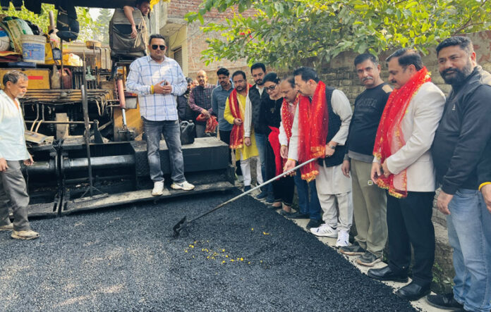 Baldev Singh Billawaria kick starting the blacktopping work at Ward No 55 on Thursday.