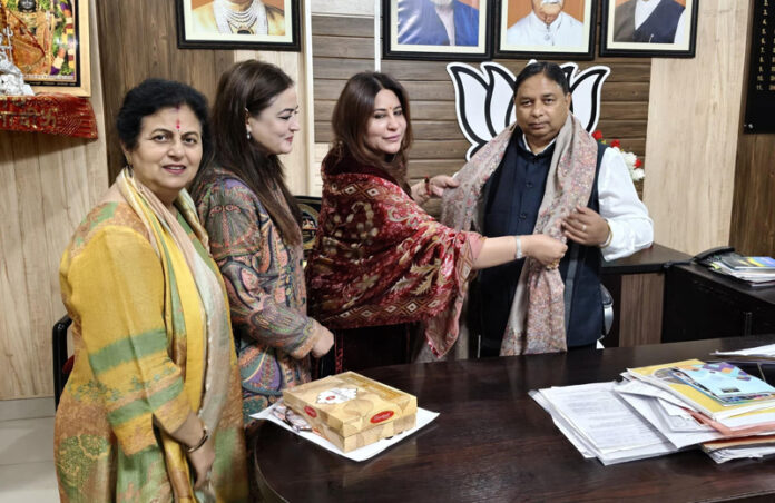 Ritika Trehan along with her team members presenting a shawl to Sat Sharma on Monday.