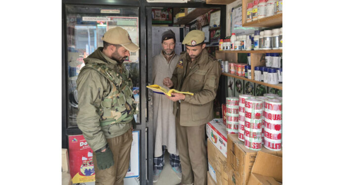 A police team inspecting a hardware store in Anantnag on Thursday.