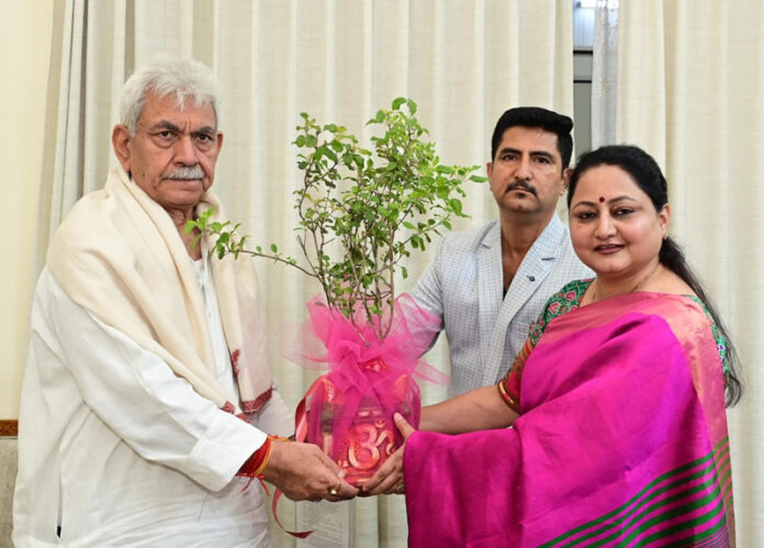 Founder & President of VGB BVSS Trust presenting a bouquet to LG Manoj Sinha.