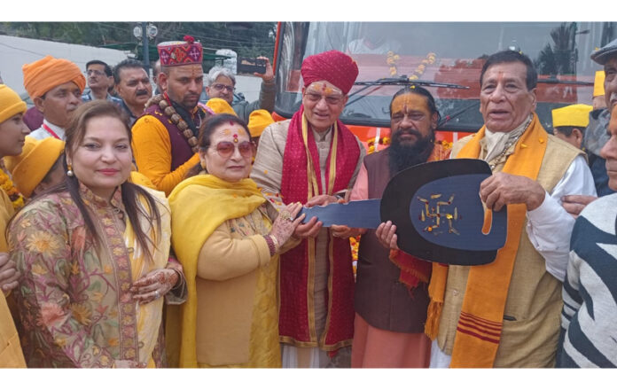 JYBT president Pawan Shastri donating keys of bus to Gyan Yagya Pathshalla representatives in Jammu on Sunday.