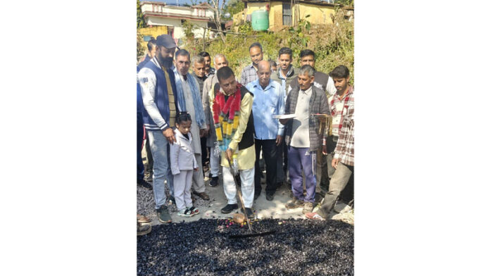 Col. Mahan Singh (Retd), DDC Chairman Kathua starting road blacktopping work in Pretha Panchayat on Thursday.