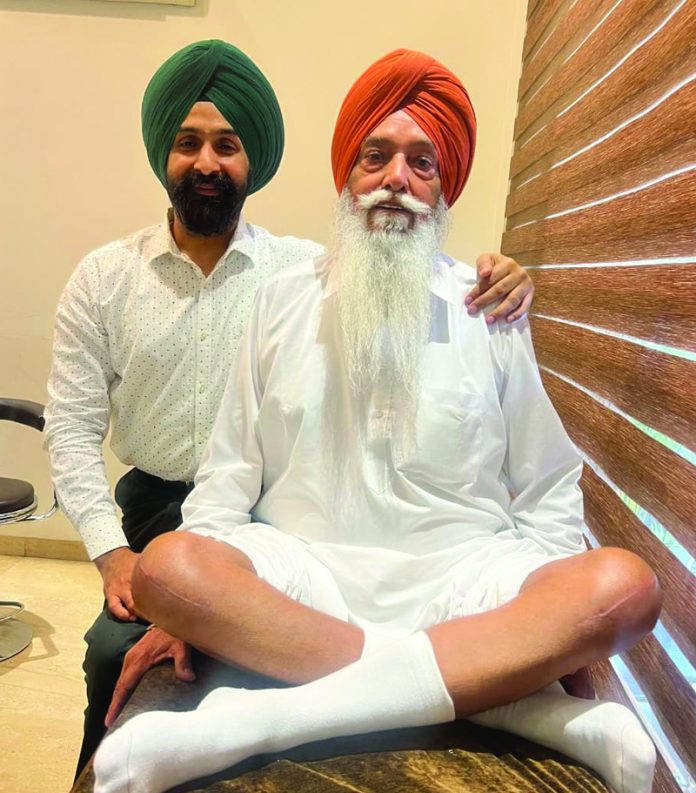 Dr Ranjit Singh posing with a patient on whom he performed bilateral knee replacement surgery.