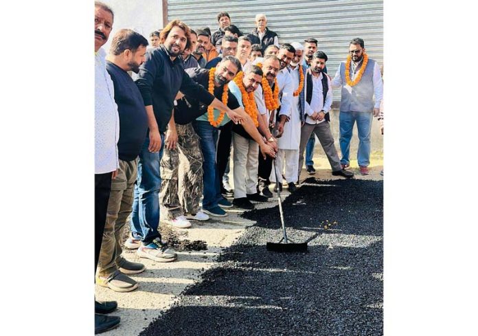 MLA Bahu, Ch Vikram Randhawa kick starting blacktopping of link road at Vidhata Nagar in Bahu constituency on Thursday.