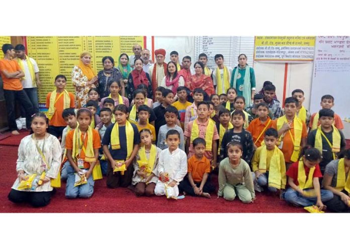 Students along with others posing for a group photograph at a 'Sanskrit Pathshala’ in Jammu on Sunday.