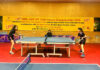 Table Tennis players in action during a match.