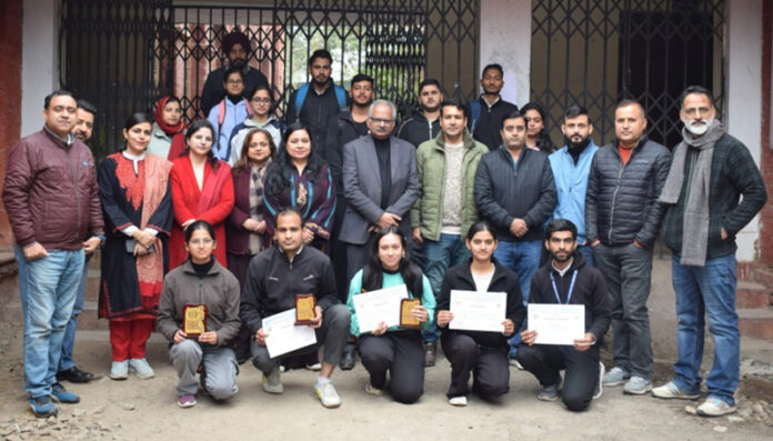 Winners posing along with certificates and dignitaries.