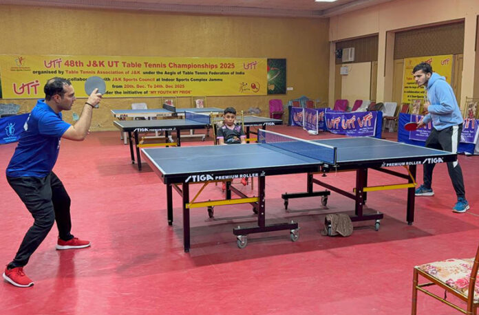 Table Tennis players in action during a match. Table Tennis players in action during a match.