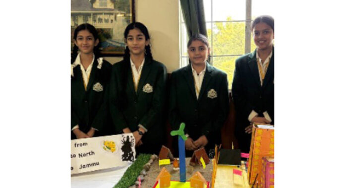 Students posing with their creative exhibits during the programme.