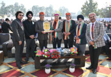 School management presenting memento to dignitary.