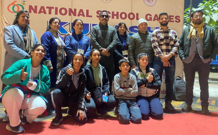 J&K Kurash team posing along with medals and support staff.