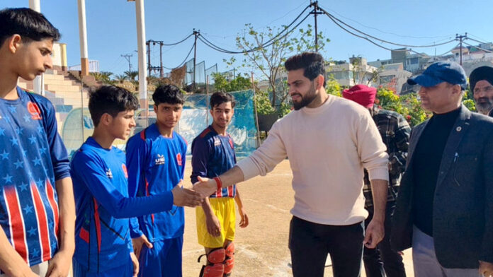 Dignitary interacting with players during a match. Dignitary interacting with players during a match.