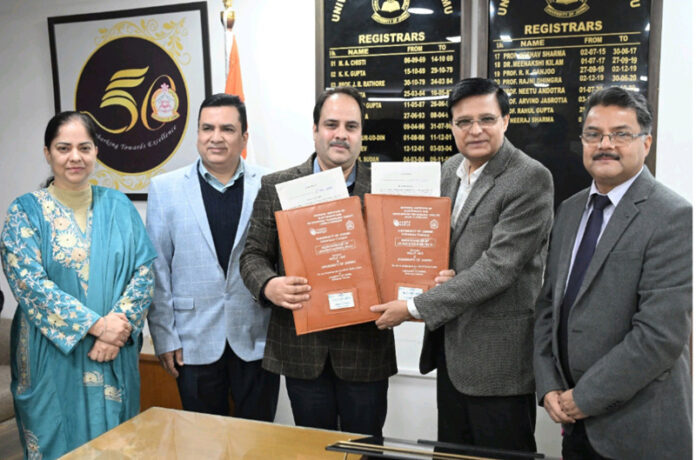 JU Registrar and NIELIT Director displaying copy of MoU signed by them. JU Registrar and NIELIT Director displaying copy of MoU signed by them.