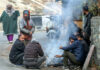 A group of people warm themselves on a roadside as Srinagar shivers. -Excelsior/Shakeel