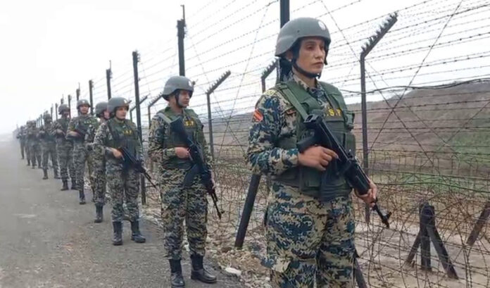 BSF women personnel patrol the IB in Jammu sector on Monday.