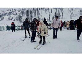 Tourists enjoy snow ski at Gulmarg on Tuesday. -Excelsior/Aabid Nabi