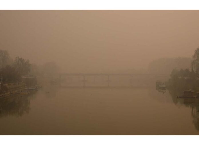 Zero Bridge in Srinagar disappears into a shroud of fog as Kashmir endures unrelenting cold wave on Sunday. -Excelsior/Shakeel
